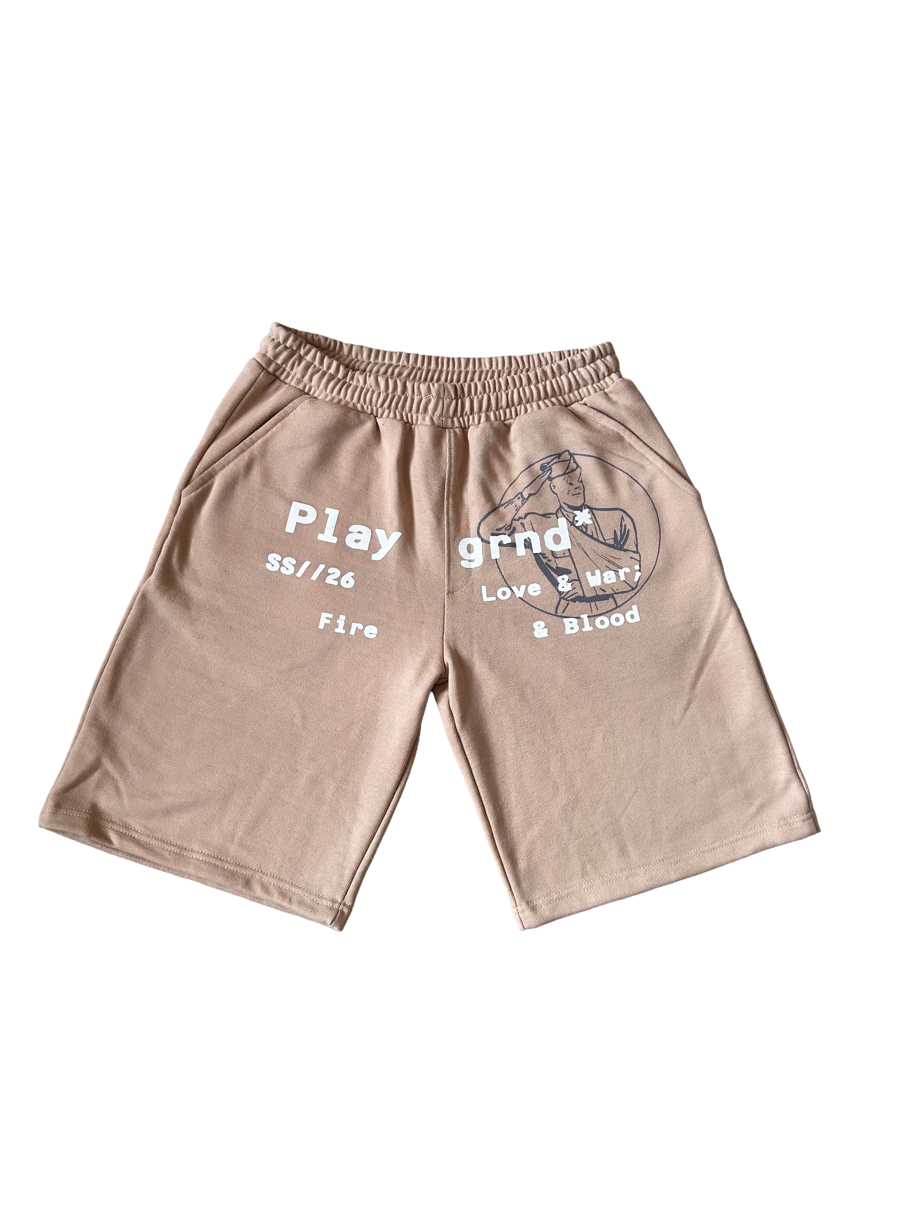 A pair of beige athletic shorts with a gray graphic print on the left leg and white text on the right leg, displayed flat against a white background.