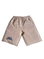 A pair of beige drawstring shorts with a gray graphic of two soldiers on the lower left leg and white text on the back pocket reading 'JUST SORTING & SURVIVES'.